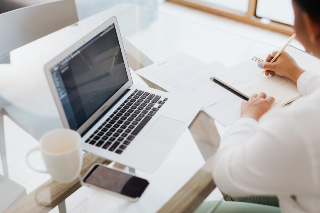 Advertiser checking Google Ads settings on laptop