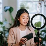 Creator filming an Instagram Reel on a smartphone mounted on a ring light