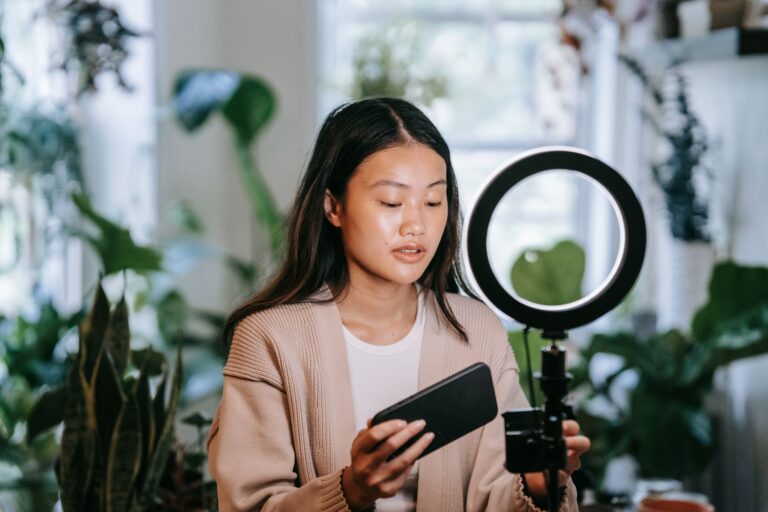 Creator filming an Instagram Reel on a smartphone mounted on a ring light