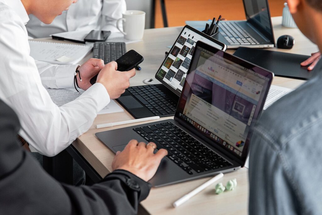 Digital marketing team planning campaigns on laptops and smartphones