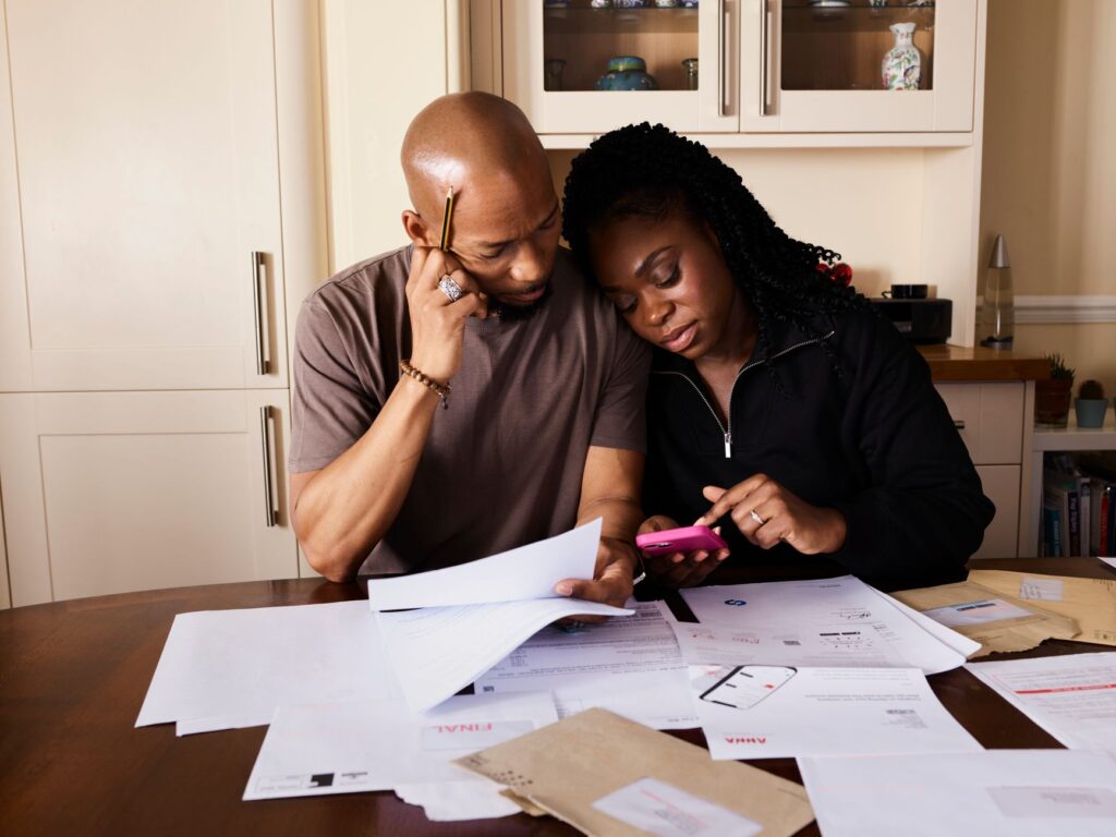 Indian family reviewing life insurance options on a smartphone, illustrating ChatGPT ads in India