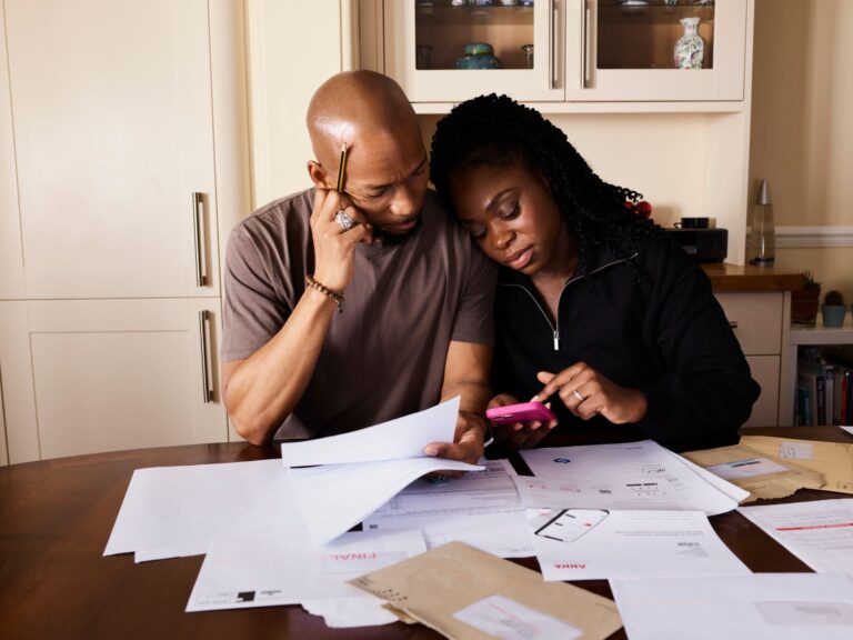 Indian family reviewing life insurance options on a smartphone, illustrating ChatGPT ads in India