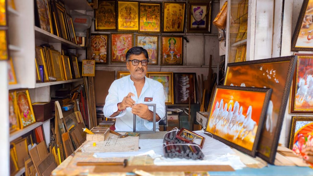 Indian shop owner updating a Google Business Profile for local SEO
