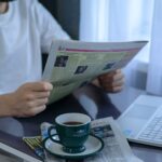Laptop, newspaper and coffee on a desk for the weekly digital marketing news roundup