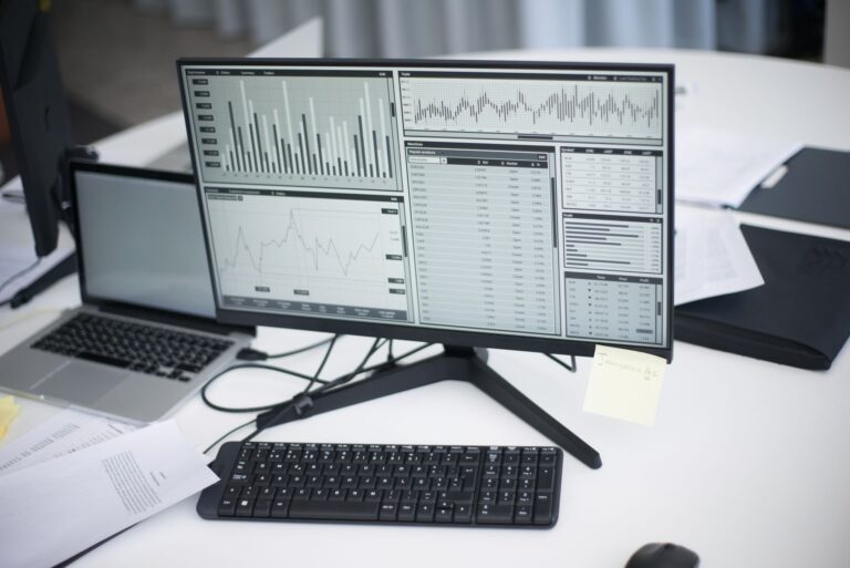 Laptop showing a Google Ads style analytics dashboard on an office desk