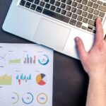 Laptop showing website analytics charts, illustrating Microsoft Clarity AI Visibility tracking of AI bots and AI traffic