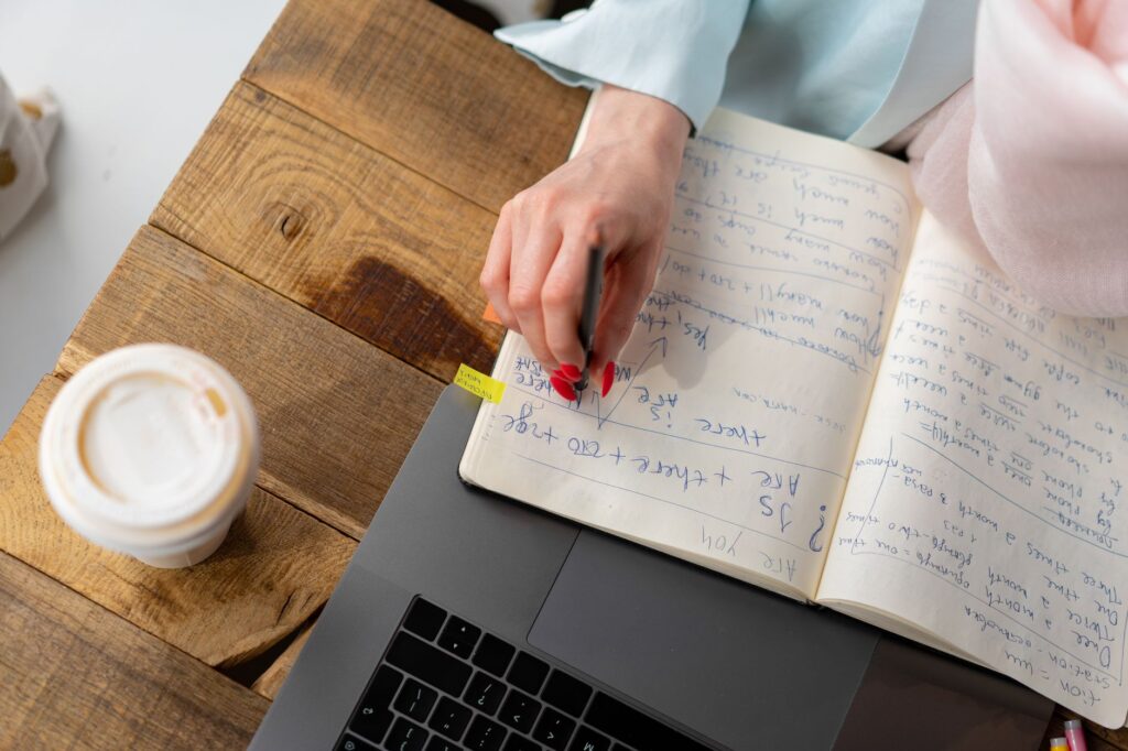 Marketer keeping a test log of YouTube A/B testing results in a notebook