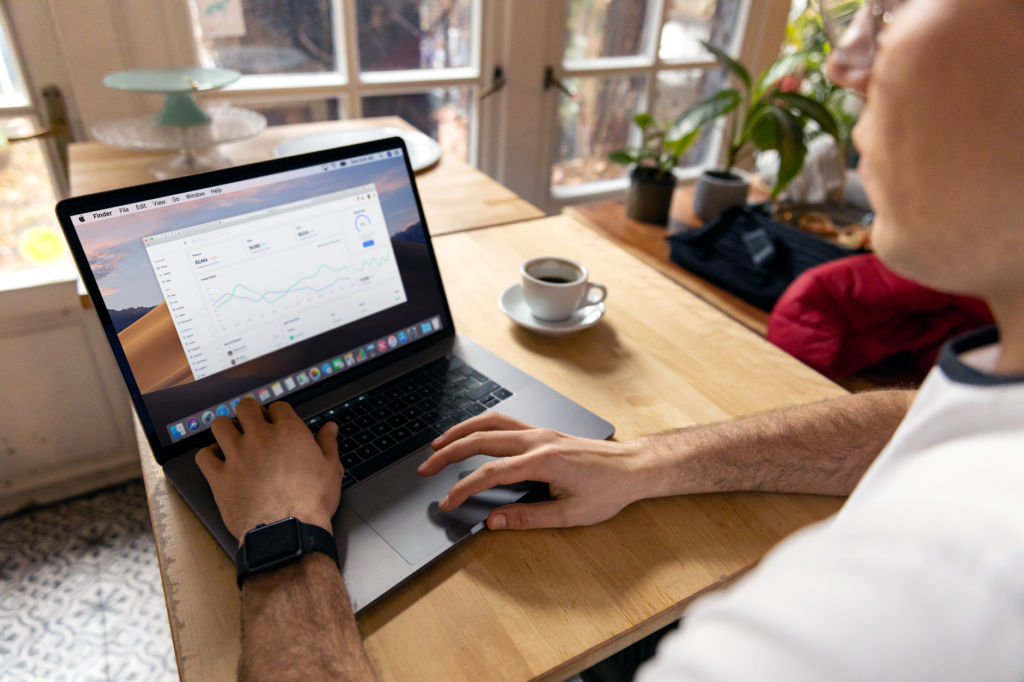 Marketer reviewing campaign performance charts on a laptop after changing Google Ads customer lifecycle goals
