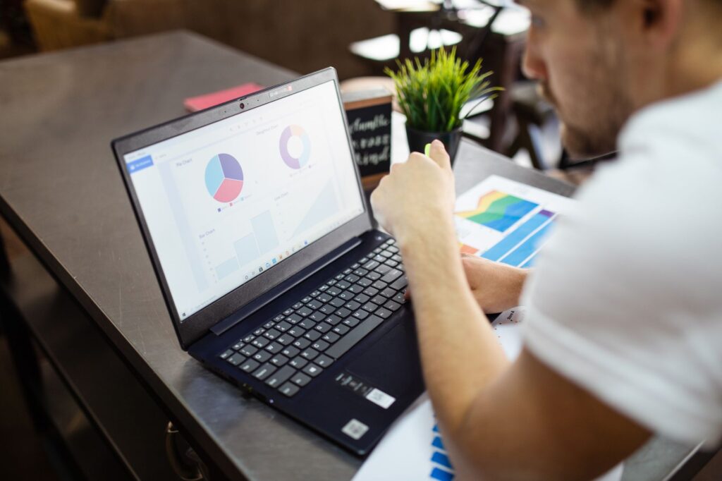 Marketer reviewing website conversion rate charts on a laptop