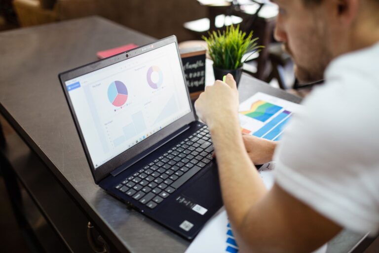Marketer reviewing website conversion rate charts on a laptop