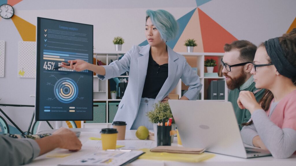 Marketing team reviewing AI citation and topic reports on a large screen