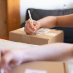 Online seller packing parcels for delivery, illustrating Meesho ads and seller costs