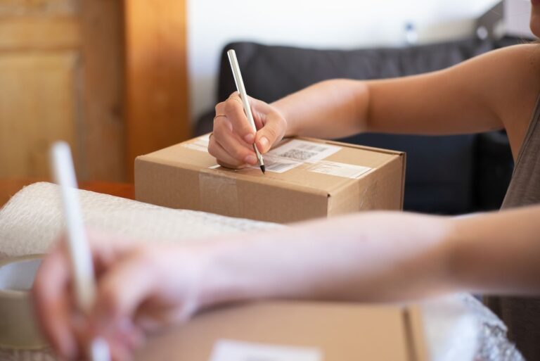 Online seller packing parcels for delivery, illustrating Meesho ads and seller costs