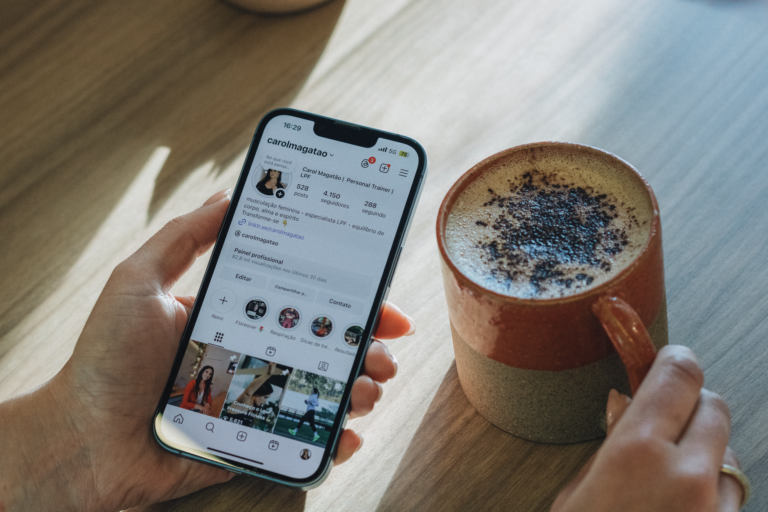 Person scrolling an Instagram feed with sponsored Meta ads on a smartphone
