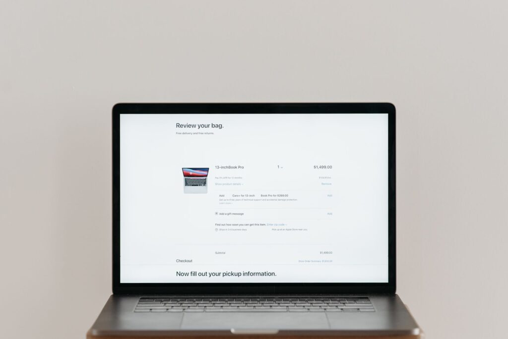 Shopper checking out on a laptop, illustrating Google Ads customer lifecycle goals for new customer acquisition
