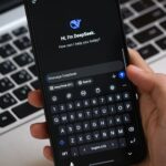 Smartphone showing a ChatGPT conversation where sponsored ads can appear below answers