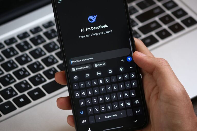 Smartphone showing a ChatGPT conversation where sponsored ads can appear below answers