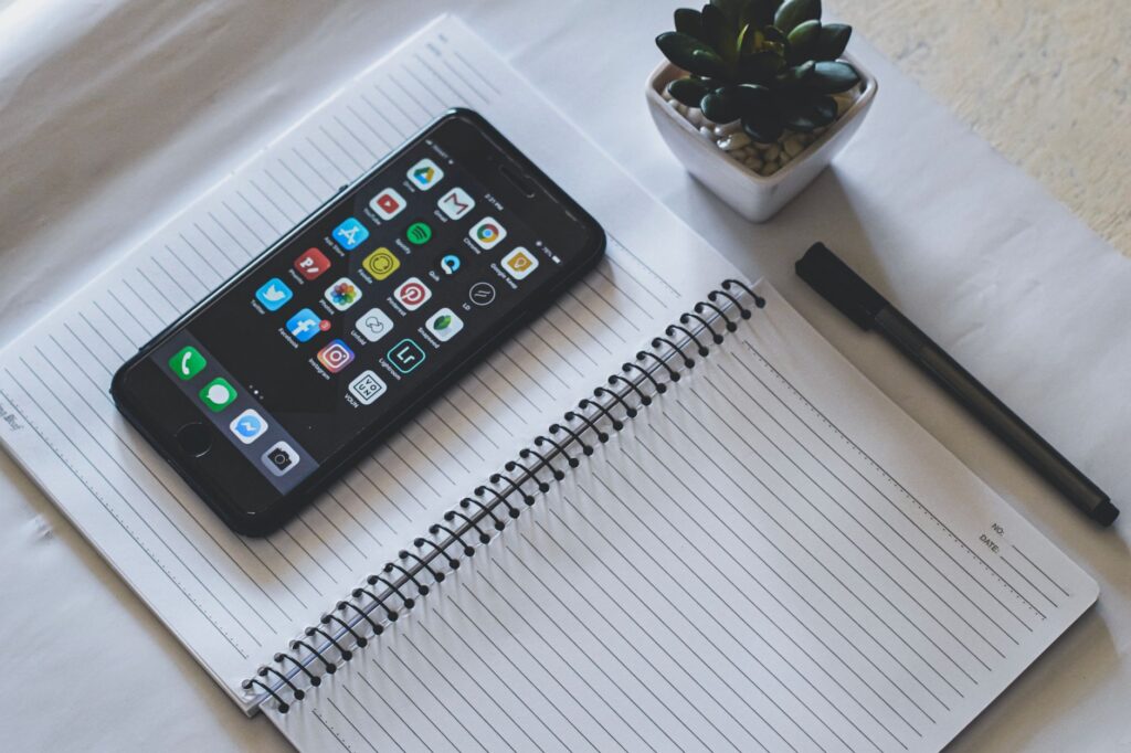 Smartphone with social media apps on a desk, representing social media marketing strategy for Indian brands