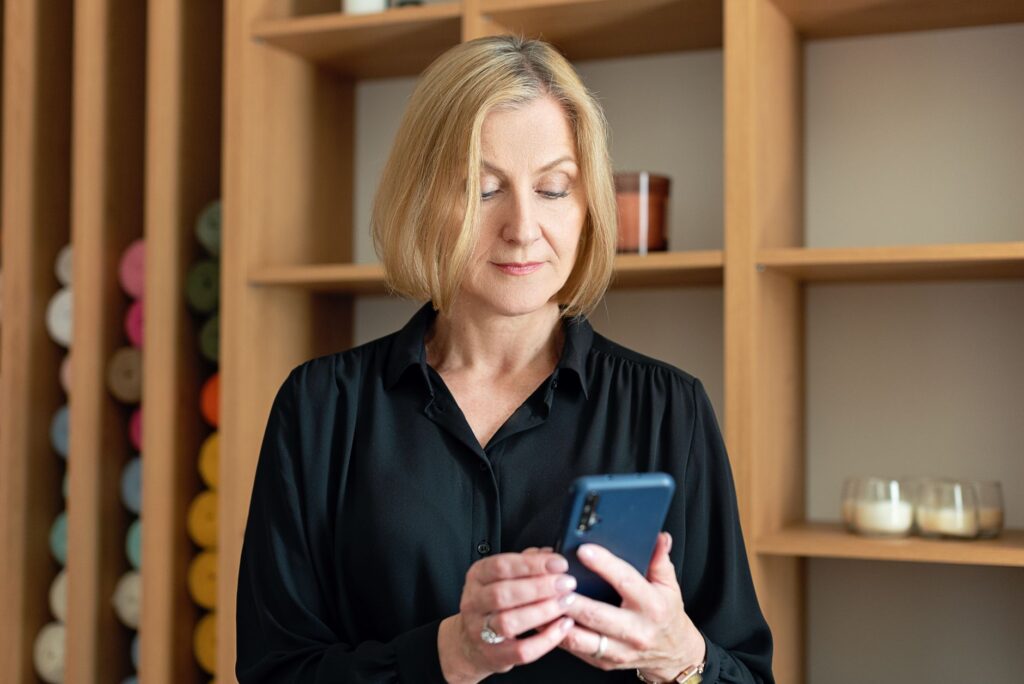 Woman reading marketing email on her phone, the moment a spam complaint happens